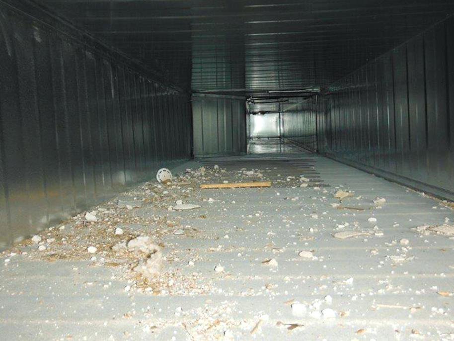 The interior of a large, dirty commercial air duct filled with debris, showing the need for cleaning by Fresh N Clean Duct Cleaning in Arvada, CO.