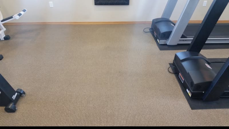 A dirty, stained commercial carpet in a gym setting, ready for cleaning by Pro Floor Restore in Appleton, WI