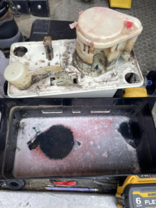 A dirty condensate pump disassembled for maintenance, showcasing HVAC service by Viking Mechanical LLC in Rapid City, SD.