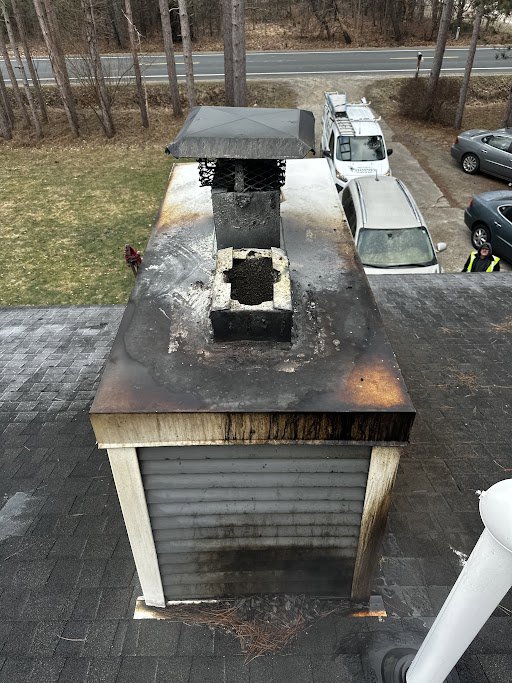 A heavily soiled and potentially damaged chimney cap and top of a chimney, indicating a need for service from Midtown Chimney Sweeps in Golden, CO.