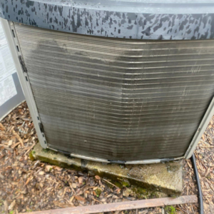 A close-up view of a dirty and potentially damaged HVAC condenser coil, indicating a need for service from KAP'S HVAC in Portland, OR.