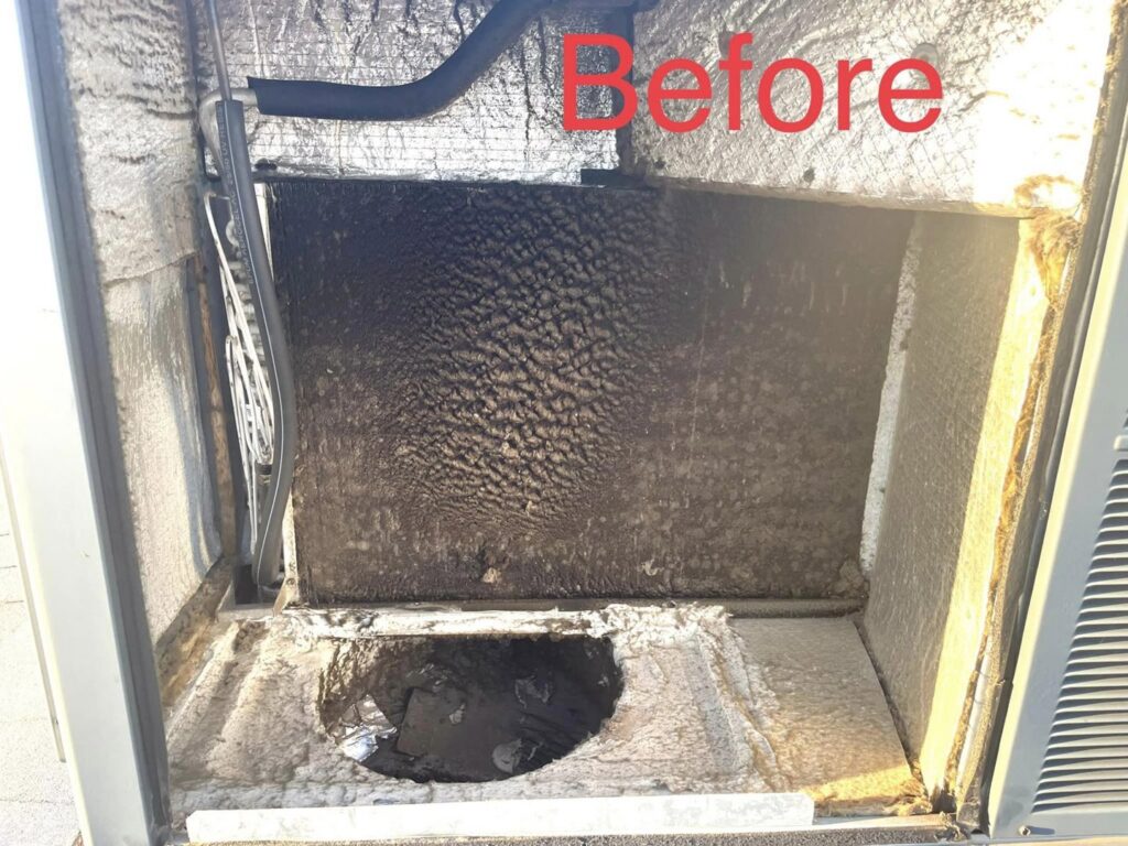 A dirty evaporator coil inside an HVAC unit before cleaning by Kaluas HVAC Mechanical Services in Phoenix, AZ