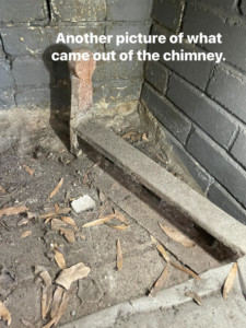 A dirty fireplace with leaves and debris, showing the condition before a chimney sweep by Southern Chimney and Duct Clean in Monroe, LA.