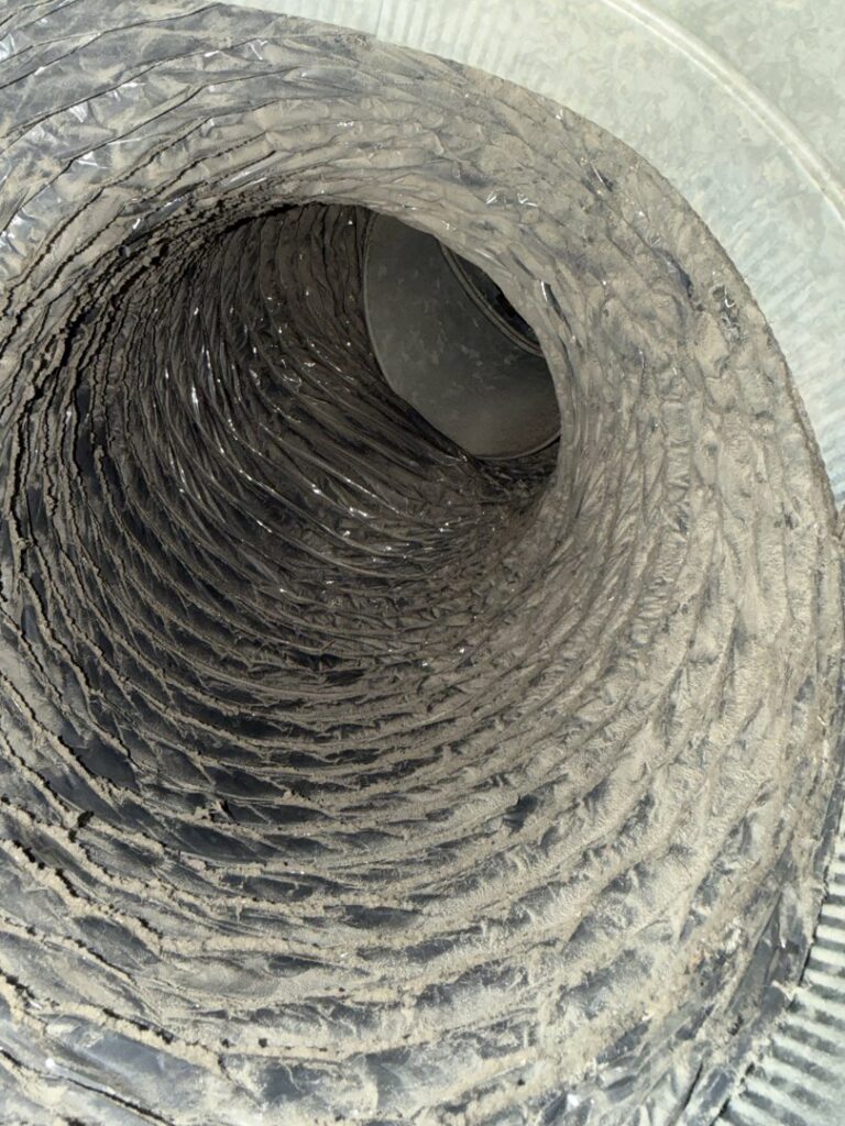 A very dirty flexible HVAC air duct interior, indicating the need for professional cleaning by AirHero.Pro in Lafayette, LA.