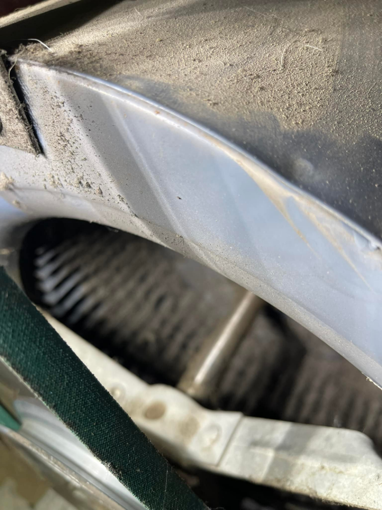 A close-up of a dirty furnace blower wheel needing cleaning by Aaron Hamilton Heating in Brunswick, ME.