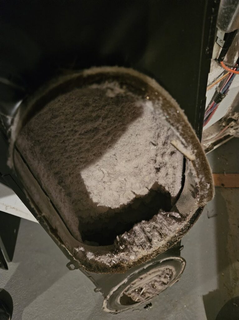 An extremely dirty HVAC air duct, indicating a need for cleaning or service from Absolute HVAC in Wilmington, DE.