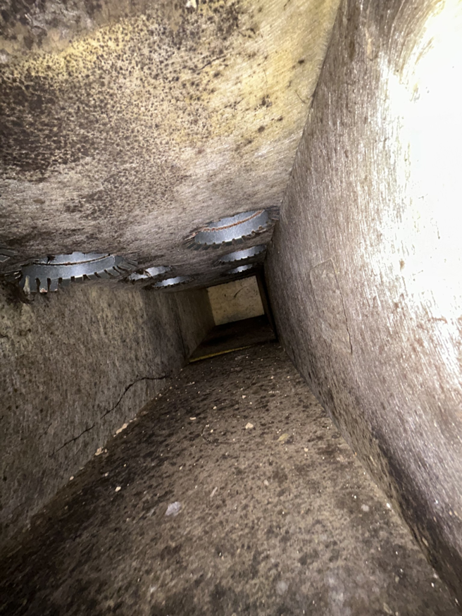 A dirty and possibly moldy interior of an HVAC air duct before cleaning by Arctic Desert Cooling & Heating in Concord, NC