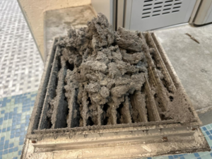 A heavily clogged and dirty HVAC air filter, indicating a need for cleaning or replacement by Trade Standard HVAC in Magna, UT.