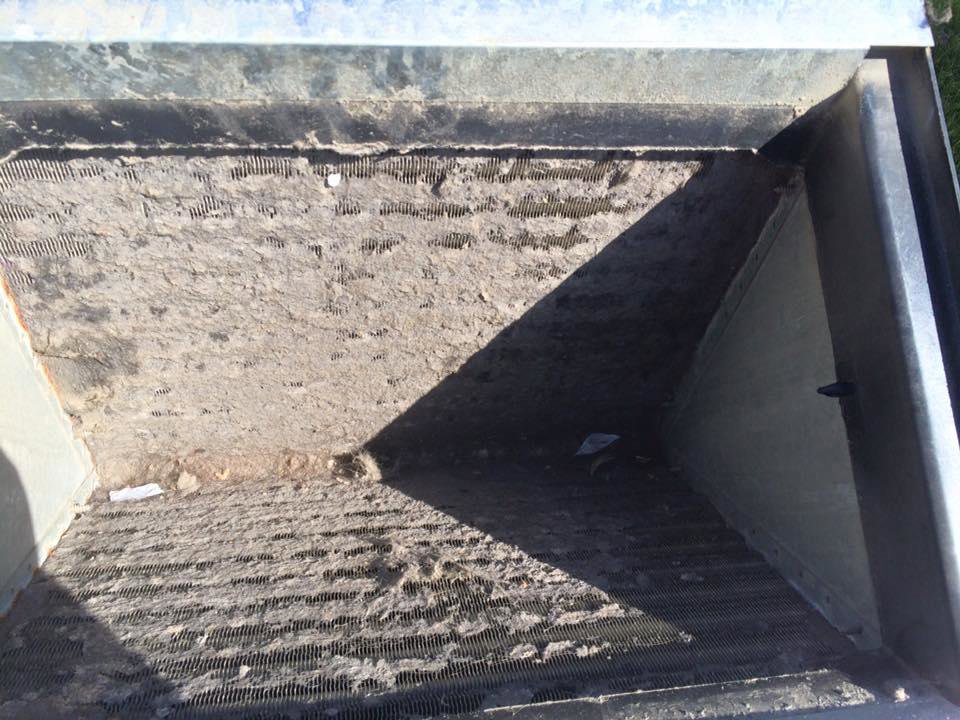 A very dirty HVAC air filter or coil needing professional cleaning, a service offered by Bergmann Heating & Air Conditioning, LLC in Orem, UT
