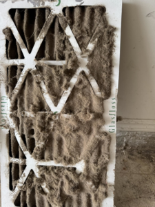A heavily soiled HVAC air filter, indicating the need for replacement or cleaning by Indoor Weather Solutions LLC in Broken Arrow, OK.