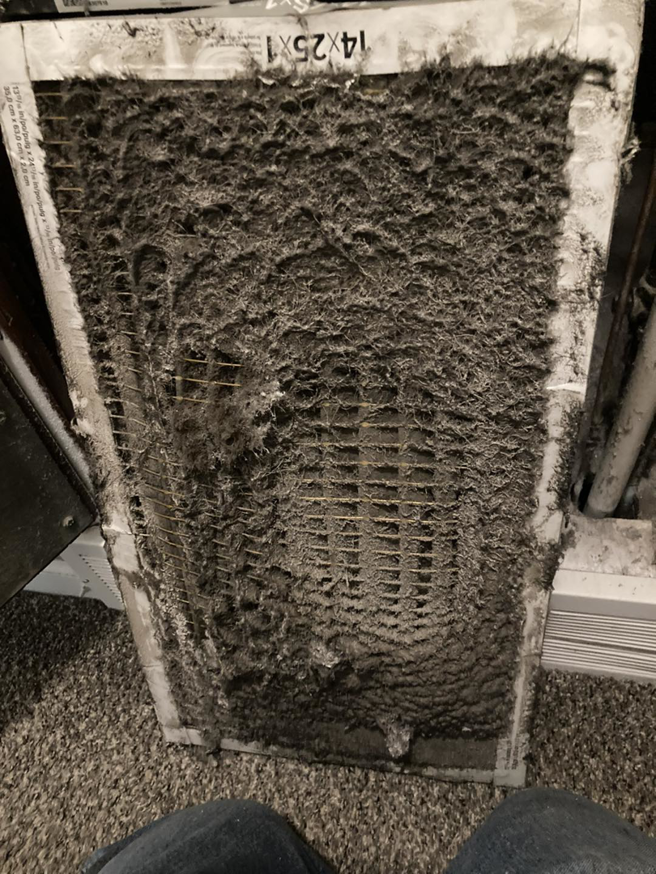 An extremely dirty HVAC air filter, indicating a need for maintenance from Integral Systems LLC in Wichita, KS.