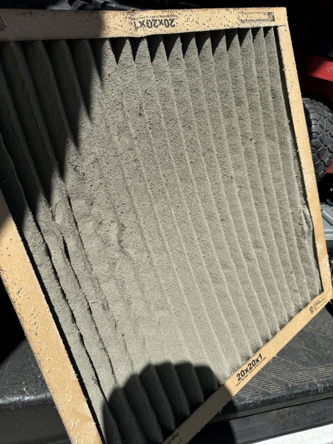 A very dirty HVAC air filter, indicating the need for maintenance from Nexus Heating & Air in Denver, CO.