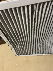 A close-up of a dirty HVAC air filter, indicating a need for replacement or cleaning by Nevils Heating and Cooling in Chicago, IL.