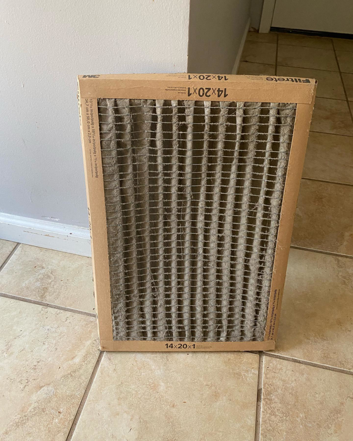 A very dirty HVAC air filter ready for replacement by B & H Heating and Air Services LLC in Local City, ST.
