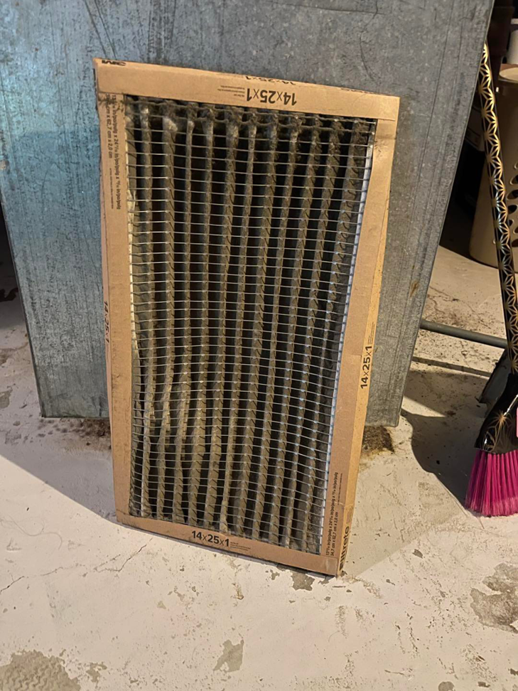 A very dirty HVAC air filter, indicating the need for replacement, handled by Bowmans Heating and Air LLC in Middletown, KY