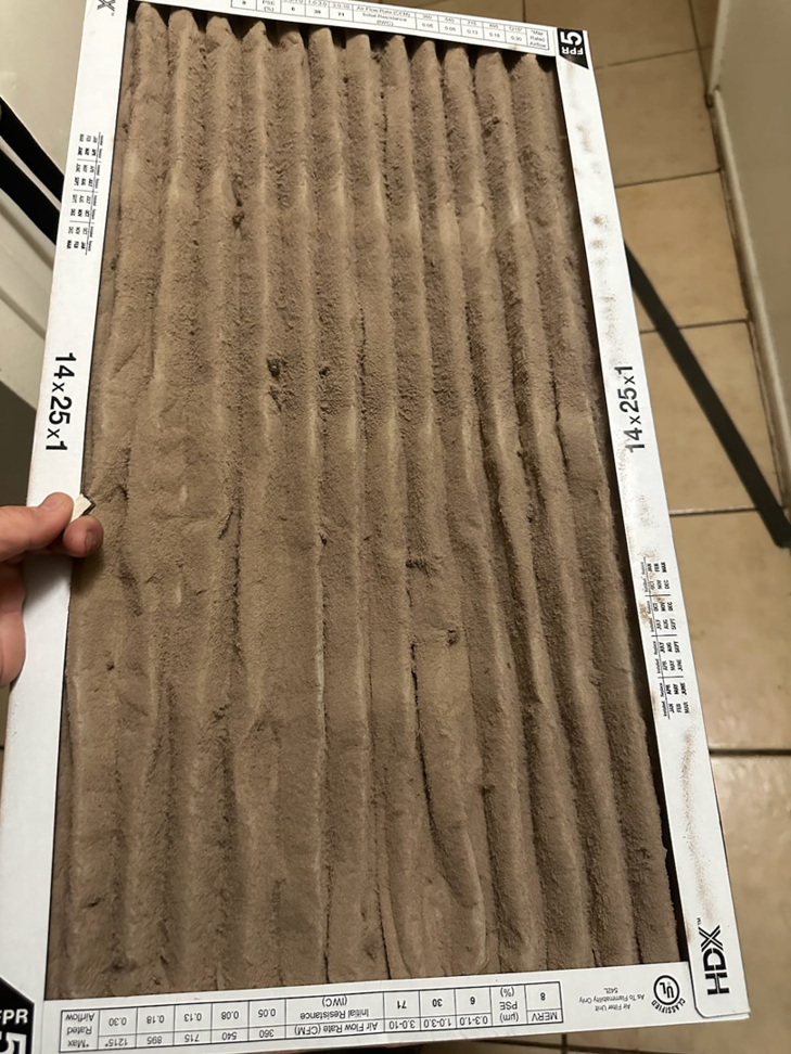 A very dirty HVAC air filter, indicating the need for replacement by Cardinal State in Mesa, AZ.