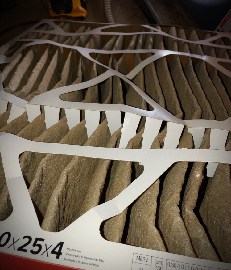 A close-up of a dirty HVAC air filter, indicating the need for replacement by York's Quality Air in Indianapolis, IN.