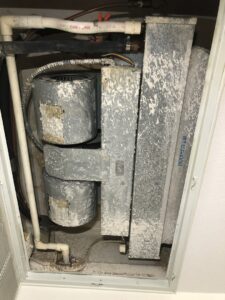 Dirty HVAC air handler components, possibly indicating a need for cleaning or maintenance by Peace & Comfort Heating and Air in San Diego, CA.