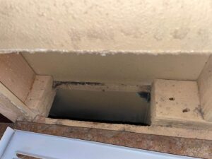 A dirty HVAC air return vent opening in a wall, indicating the need for professional cleaning by Aero Brush Duct Cleaning in Billings, MT.