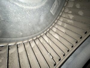 A dirty HVAC blower fan inside a unit, showing the need for professional cleaning by Service Legends in Des Moines, IA.