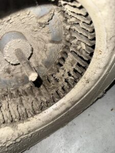 A close-up of a severely dirty HVAC blower fan, illustrating the need for professional cleaning services from Greenley Heating & Cooling in Waterloo, IA