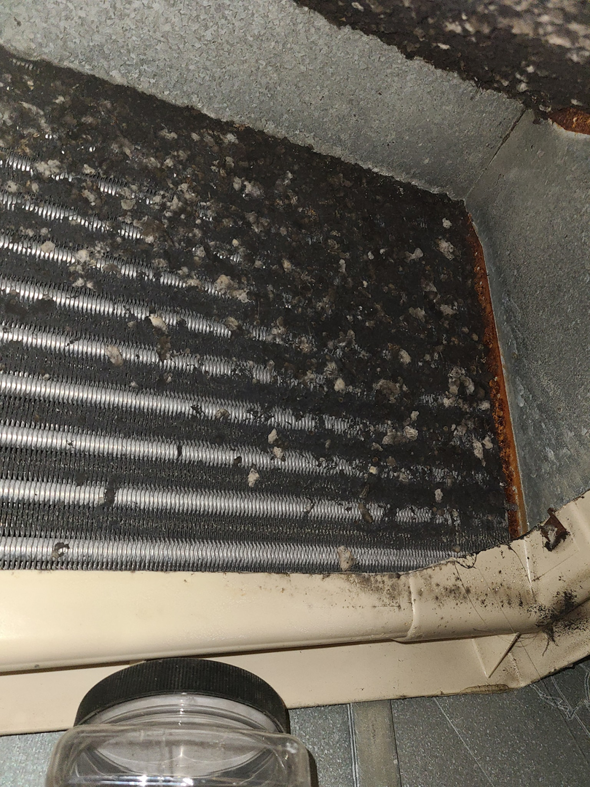 A close-up view of a heavily soiled HVAC coil requiring cleaning by ARC Mechanical Inc in South Elgin, IL.