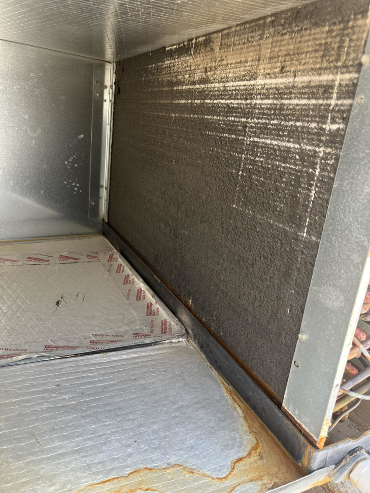 A close-up view of a dirty HVAC coil during an inspection by B3 Refrigeration LLC in Tempe, AZ