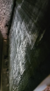 A close-up view of a dirty HVAC coil requiring cleaning or service by Proambient Mechanical in Elgin, IL