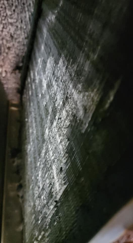 A close-up view of a dirty HVAC coil requiring cleaning or service by Proambient Mechanical in Elgin, IL