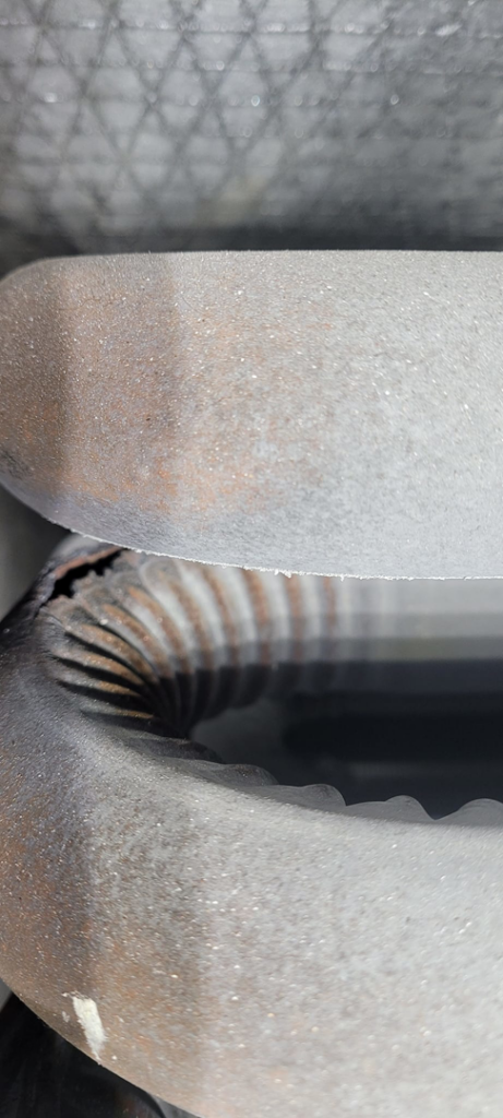 A close-up view of a dirty HVAC coil requiring maintenance from Western Sheet Metal Works Inc. in Aurora, CO.