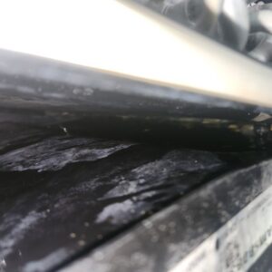 A close-up of a dirty HVAC coil or drain pan requiring service by Southwest Florida Air Quality in Cape Coral, FL