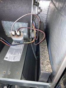 The interior of an HVAC unit showing a dirty coil or filter, indicating a need for cleaning by Star Quality Air Duct Cleaning in Silver Spring, MD.