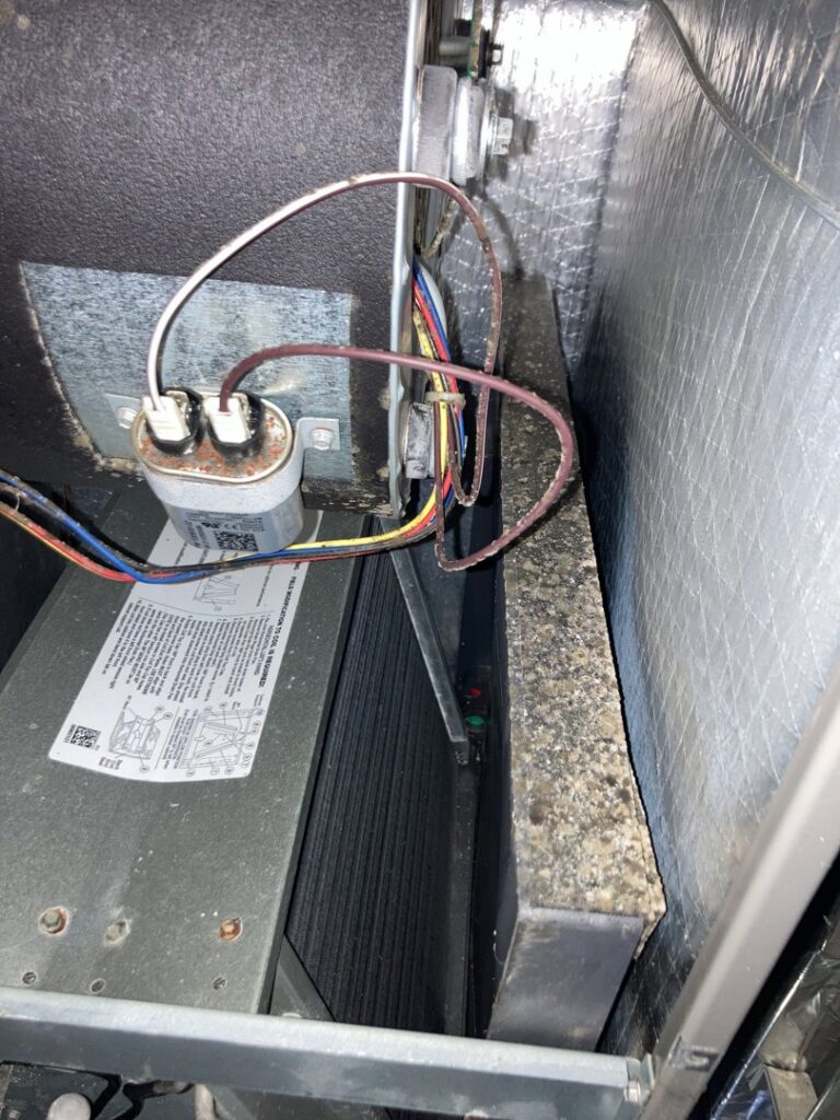 The interior of an HVAC unit showing a dirty coil or filter, indicating a need for cleaning by Star Quality Air Duct Cleaning in Silver Spring, MD.