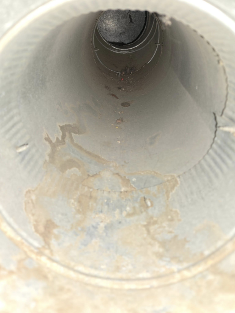 The interior of a dirty HVAC duct showing grime and moisture, ready for cleaning by Aero Brush Duct Cleaning in Billings, MT.