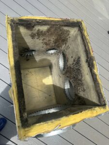 A dirty, insulated HVAC duct section, possibly removed for cleaning or replacement by Arctic Desert Cooling & Heating in Concord, NC