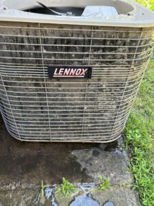A dirty Lennox outdoor AC unit showing the need for cleaning or maintenance by Oklahoma Climate Solutions in Oklahoma City, OK.