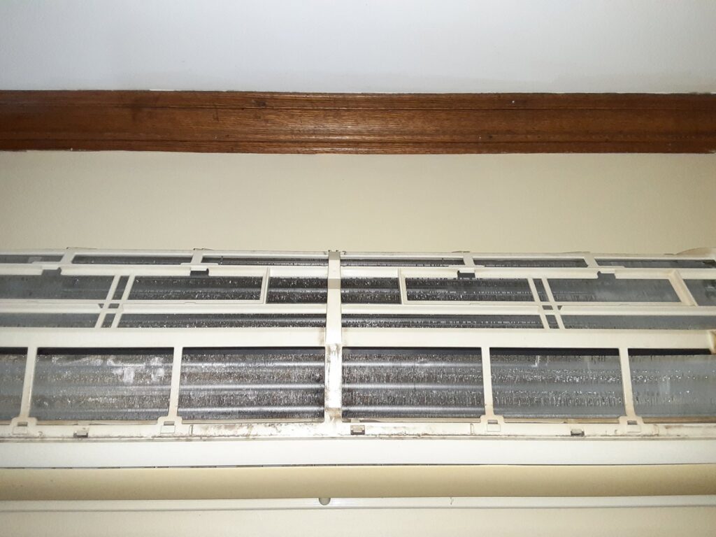 Close-up of dirty coils inside a mini-split unit, ready for cleaning by Elements Heating & Cooling LLC in Minneapolis, MN.