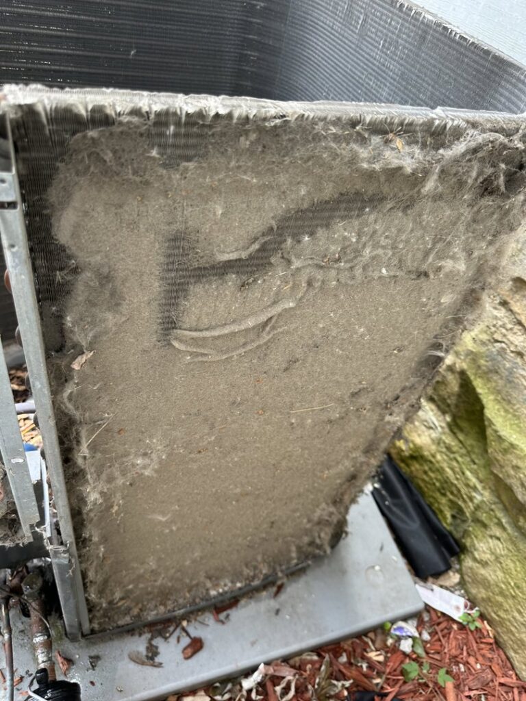 An extremely dirty outdoor air conditioning coil requiring cleaning by Nacho Heating & Cooling Plus Co. in Crest Hill, IL