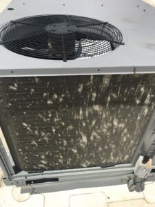 A close-up of a dirty outdoor air conditioning coil needing maintenance from Epic Heating & Cooling in Wichita, KS.