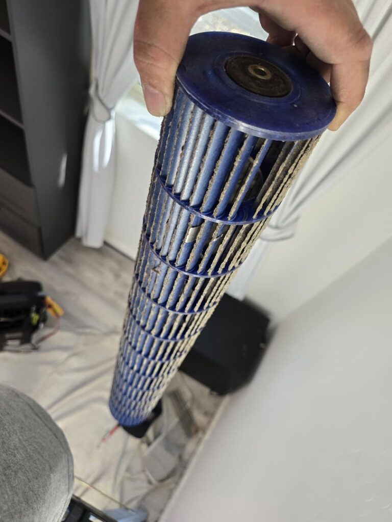 A close-up view of a dirty outdoor AC unit coil needing cleaning from Quantum Cooling & Heating in Mesa, AZ.