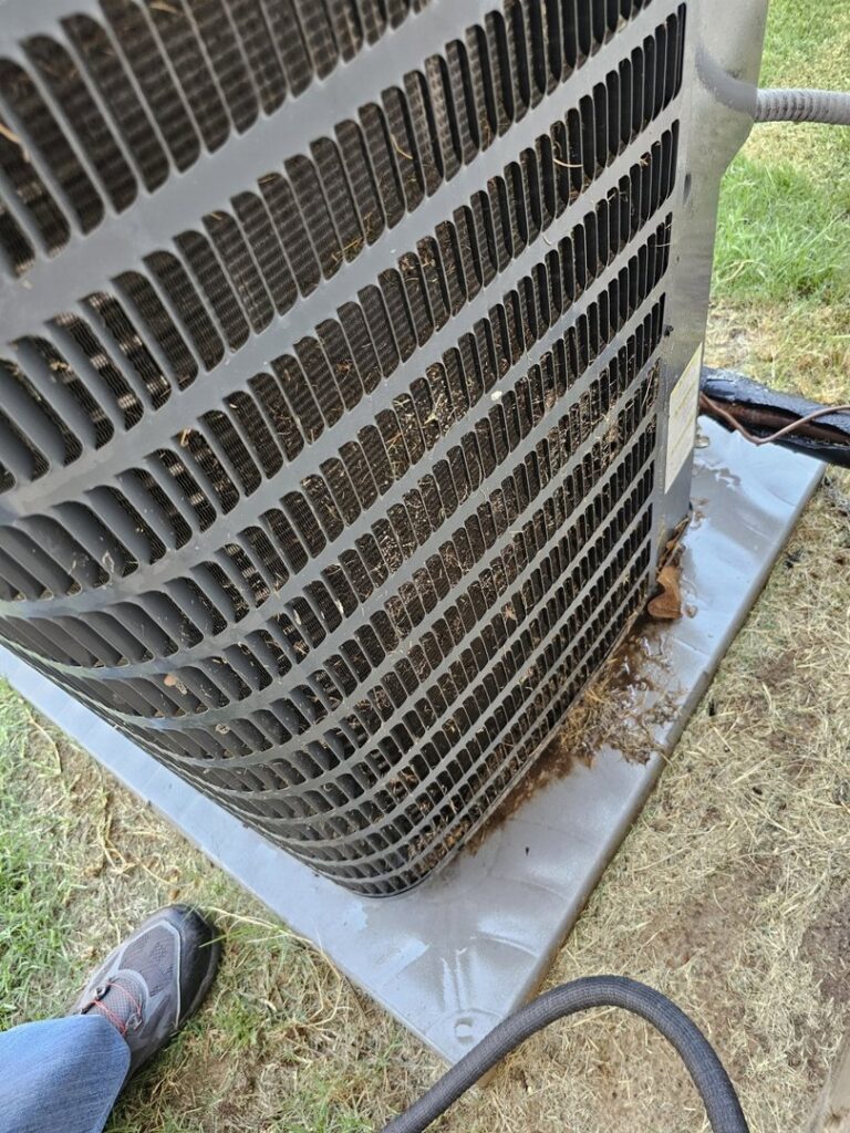 A close-up view of a dirty outdoor AC condenser coil, indicating a need for cleaning by MasterCraft Mechanical, LLC. in Haslet, TX.