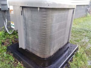 A dirty outdoor AC condenser unit, indicating a need for cleaning or service by TAG Heat N Air in North Little Rock, AR.