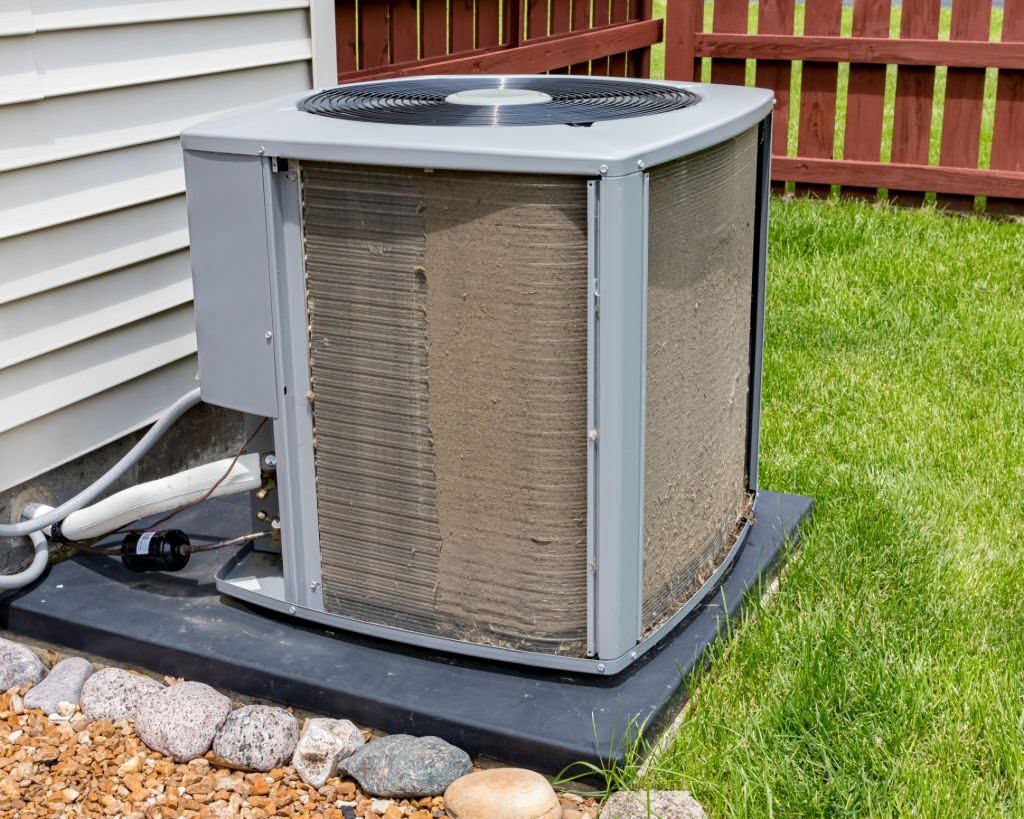 A very dirty outdoor AC condenser unit in need of cleaning or service by Air Done Right in Philadelphia, PA.