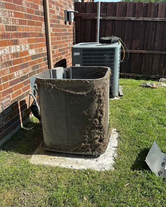 An outdoor AC unit with heavily clogged coils needing cleaning from CLM Mechanical in Dallas, TX