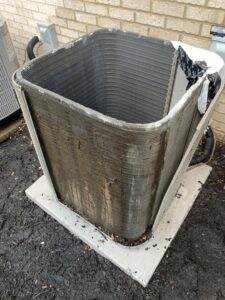 Dirty outdoor air conditioning unit coils requiring cleaning or maintenance from PureAir HVAC in Bel Air, MD.