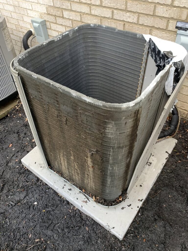 Dirty outdoor air conditioning unit coils requiring cleaning or maintenance from PureAir HVAC in Bel Air, MD.