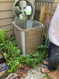 Dirty coils of an outdoor AC unit being serviced by Ash Plumbing, Drain & Sewer in Akron, OH.
