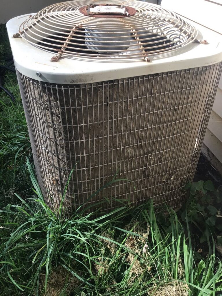 A dirty outdoor air conditioning unit in need of cleaning or service by Family Heating & Air Conditioning in Indianapolis, IN.
