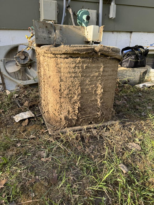 An extremely dirty outdoor AC unit requiring maintenance from Missouri River Heating & Cooling in Mandan, ND.
