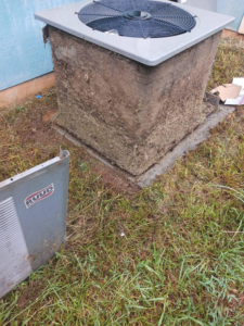 A heavily soiled outdoor AC unit with a removed panel, showing dirty coils, indicating a need for HVAC service by Omaha Heating and Air in Omaha, NE.